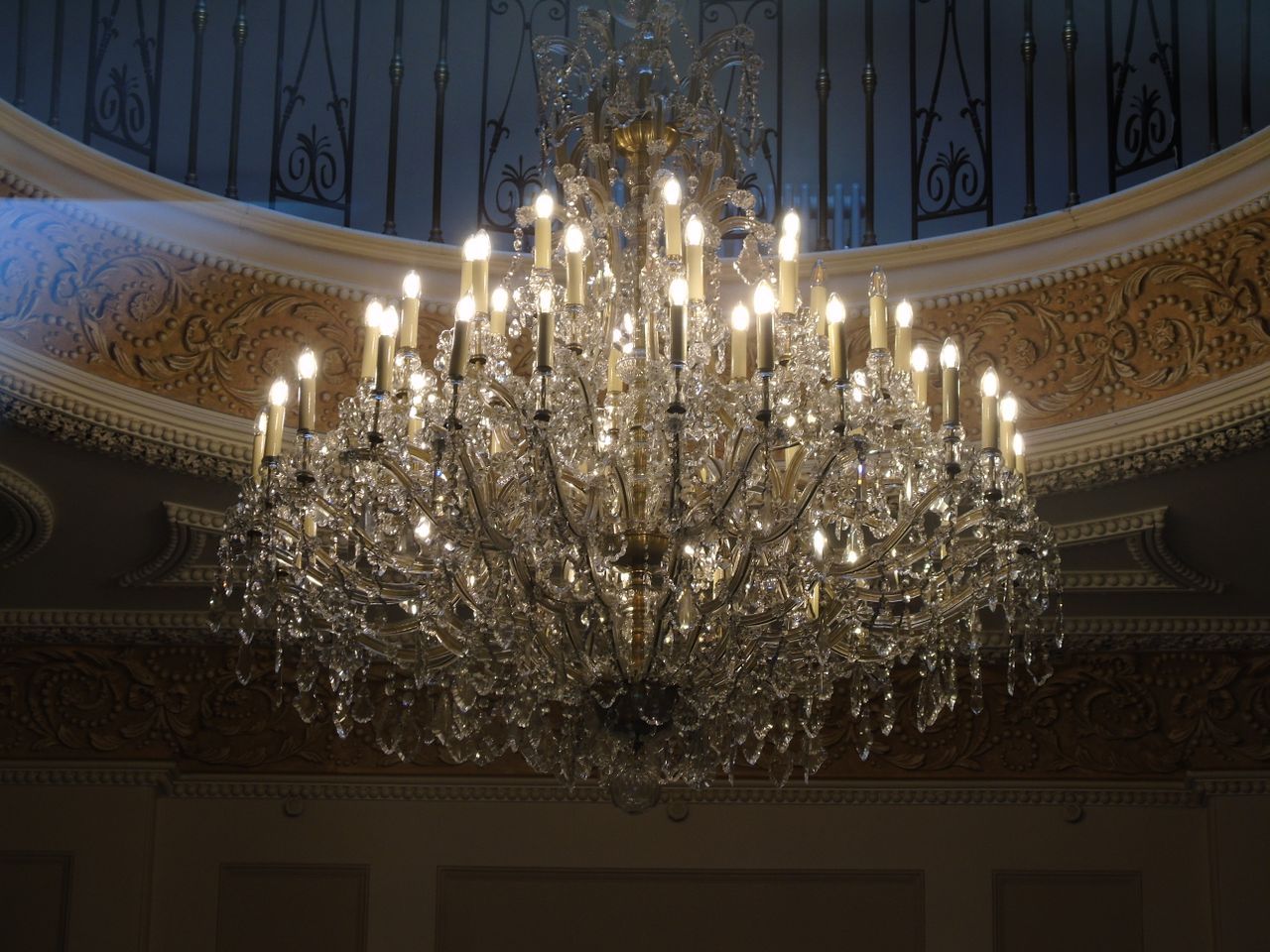 Lavish crystal chandelier with intricate details in a luxurious interior, exuding elegance and opulence.